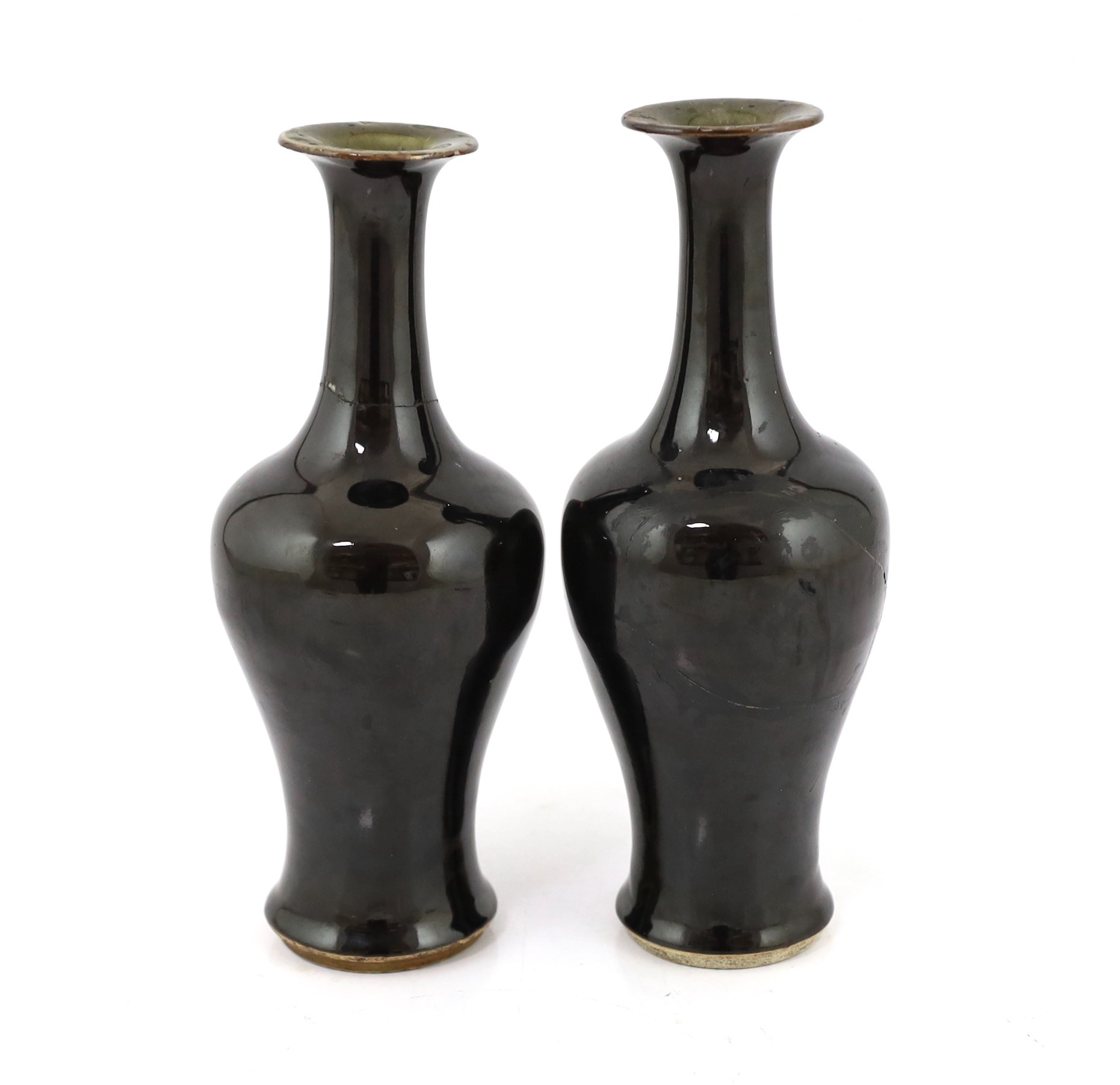 A near pair of Chinese mirror-black glazed vases, Kangxi period, both broken and glued